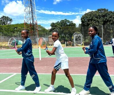 Learners with tennis rackets on the school court